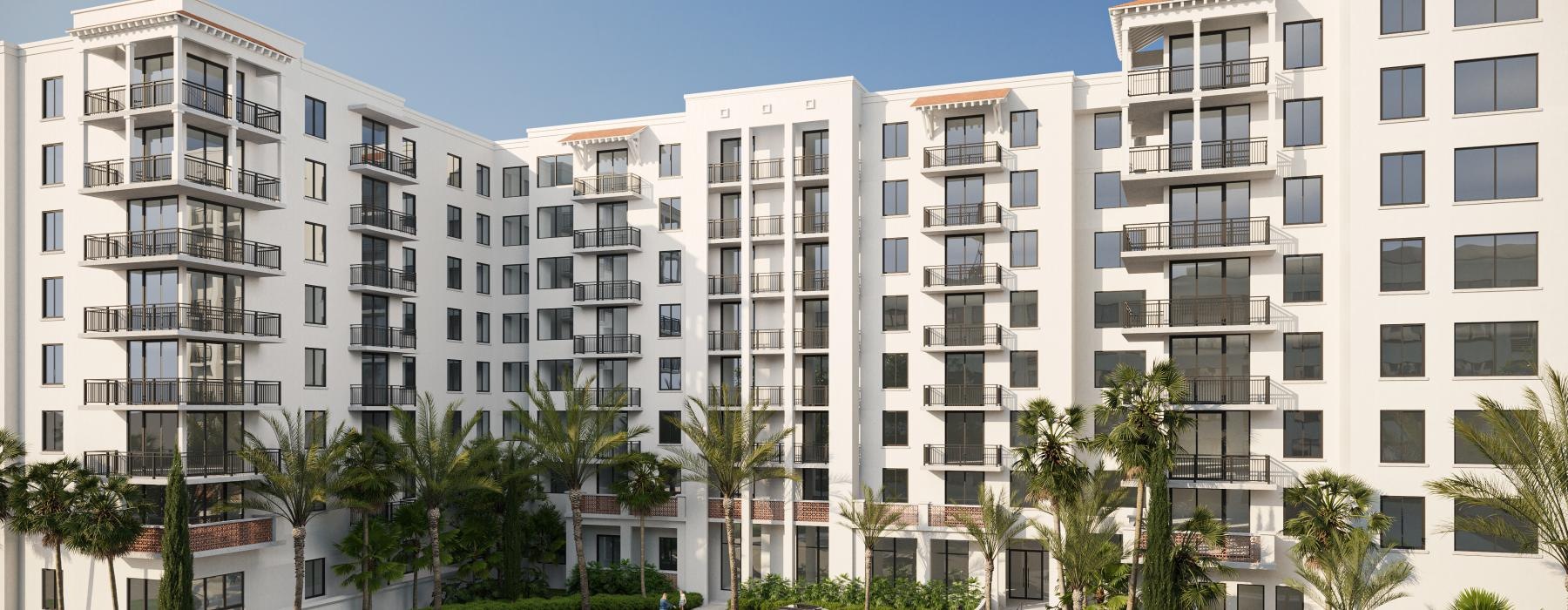 a large white building with palm trees