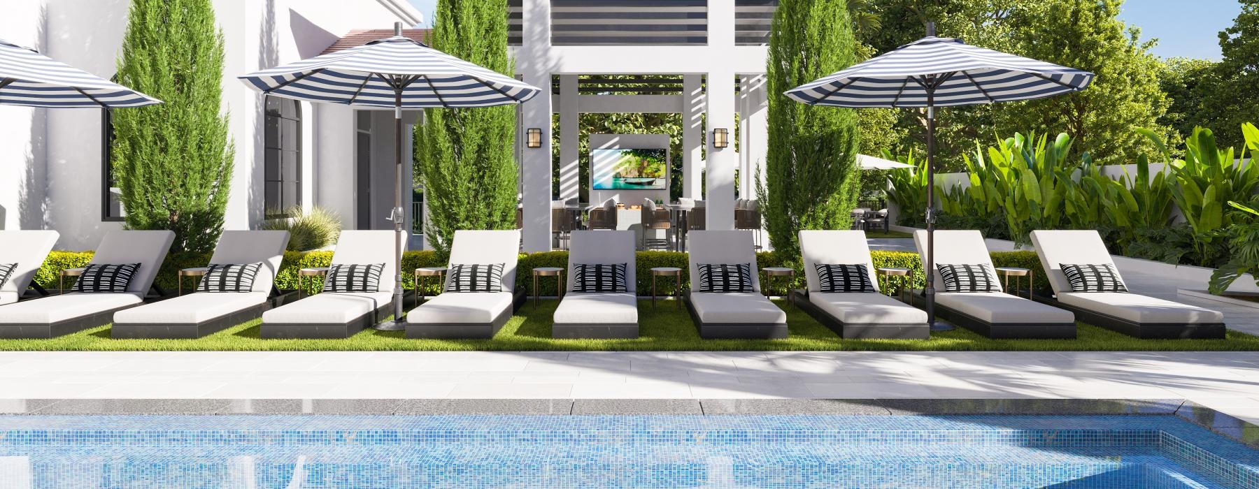 a pool with chairs and umbrellas by a building