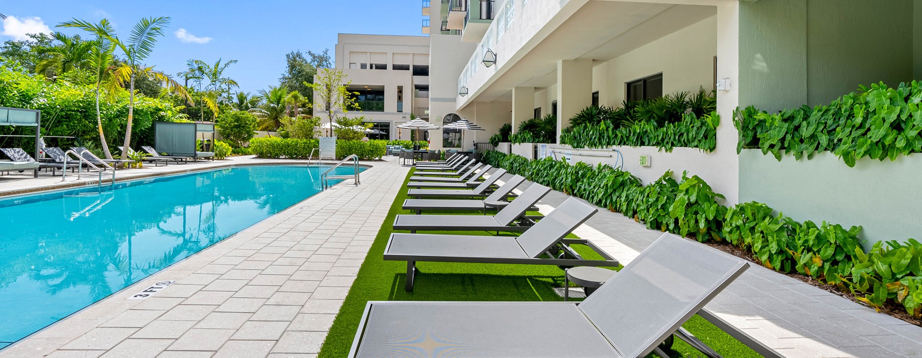 pool with lounge chairs along it
